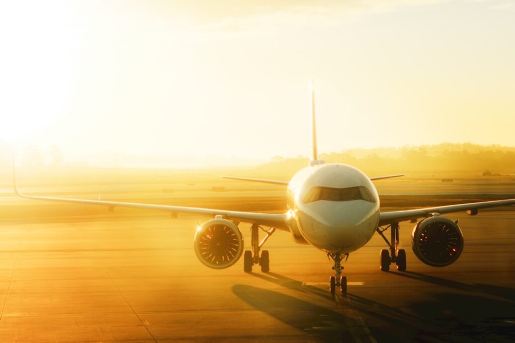 Airplane on the tarmac near Orlando International Airport at sunrise